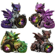 Four colorful dragon figurines with gemstones on a white background