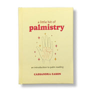 Book titled 'a little bit of palmistry' by Cassandra Eason on a beige background