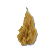 Wavy-textured yellow candle on a white background