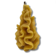 Wavy-textured yellow candle on a white background