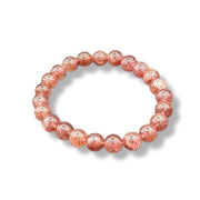 Pink beaded bracelet with white symbols on a white background