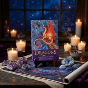 A book titled "Dragons: Your Celestial Guardians" by Diana Cooper stands upright on a small wooden easel. The cover shows a glowing orange dragon against a starry blue night sky.