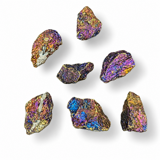 Seven raw, rough iridescent crystals with metallic rainbow sheen in purple, blue, gold, and green, arranged on a clean white background with soft drop shadows.