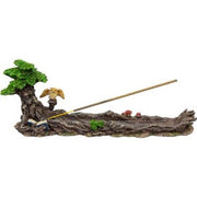 Decorative scene with a tree, small figure, and an incense stick on a white background