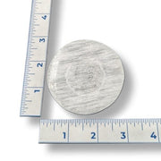 Selenite ball holder with a ruler showing its size on a white background