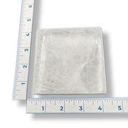 Selenite square with a ruler for scale on a white background