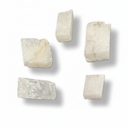 Five rough, irregular off-white stone or crystal chips with natural textured surfaces, arranged on a clean white background with soft drop shadows.