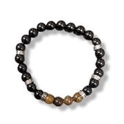Black beaded bracelet with silver accents on a white background