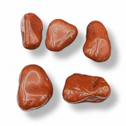 Red jasper tumbled on a white background