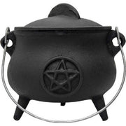 Black cast iron cauldron with a pentagram design on a white background