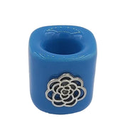 Blue candle holder with silver floral design on a white background