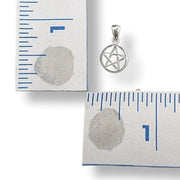 Silver pentacle pendant on a white card with measurement ruler