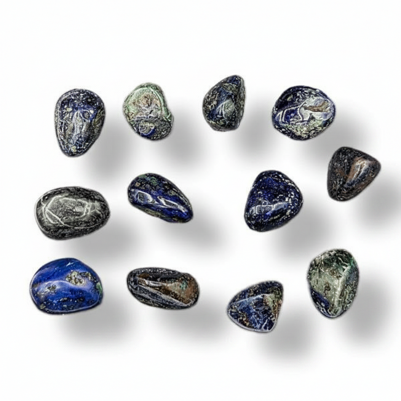 A set of polished tumbled gemstones in shades of blue, gray, and white, arranged on a clean white background with soft drop shadows.