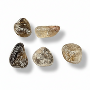 A series of polished smokey quartz stones of varying sizes, on a white background
