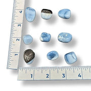 Blue marbled stones with a ruler for scale on a white background
