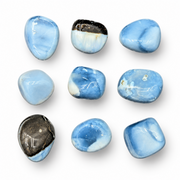 Nine polished blue tumbled stones arranged in a 3x3 grid on a clean white background.