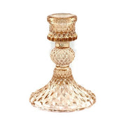 Decorative glass candle holder with textured design on a white background