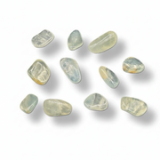 Nine polished tumbled gemstones in pale greenish-gray and translucent tones, arranged on a clean white background with soft shadows.