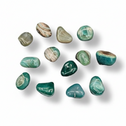 Collection of green and brown marbled stones on a white background