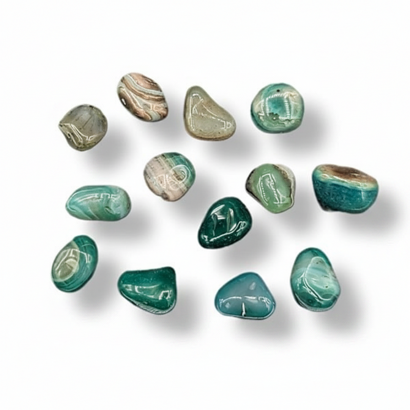 Collection of green and brown marbled stones on a white background