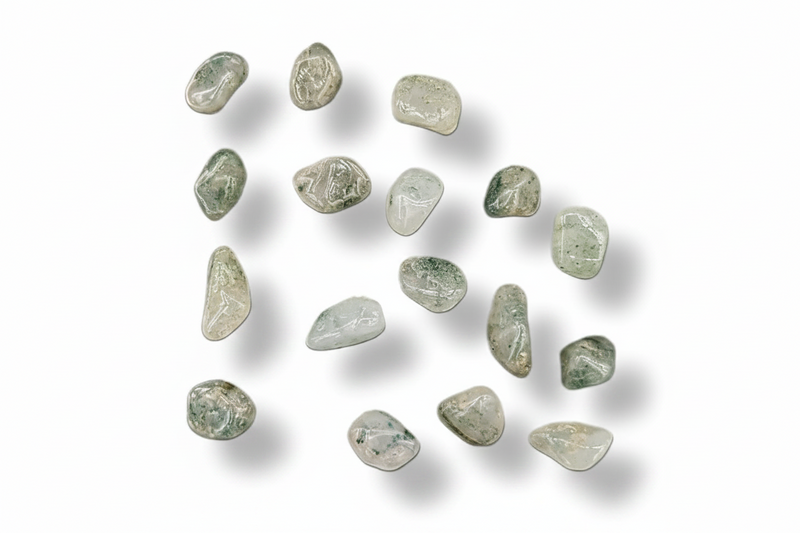 A group of small, polished tumbled gemstones in pale green, gray, and white tones, arranged on a clean white background with soft drop shadows.