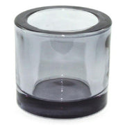 Clear glass candle holder with black rim on a white background