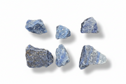 Six rough blue-gray minerals  arranged in two rows on a plain white background, each casting a soft shadow.
