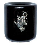 Black ceramic holder with metal witch on a white background