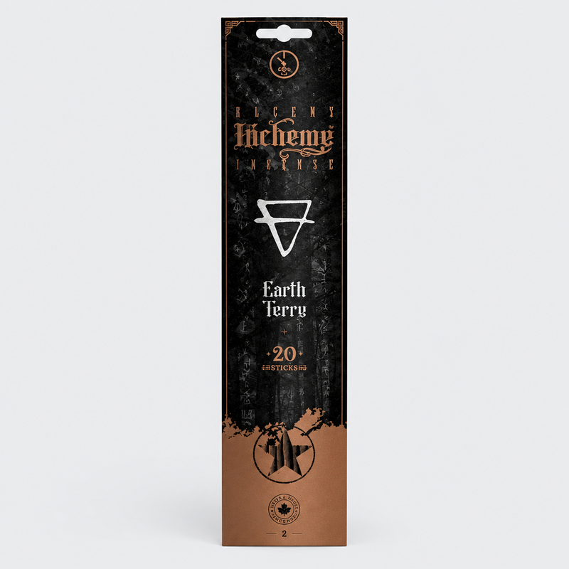 A tall, narrow retail package for Alchemy Incense Earth sticks, shown against a light gray studio background. The box is predominantly black with a warm copper-brown lower section and white and gold printed text and symbols.