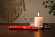 Hem Incense Frankincense 20g Approximate on a table with a candle, crystals and incense.