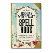 Book titled 'The Modern Witchcraft Spell Book' with decorative cover and floral elements.
