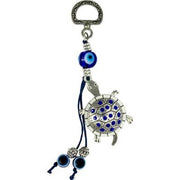 Tortoise-shaped keychain with blue eye design on a white background