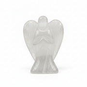 A small translucent angel figurine carved from selenite  standing with hands clasped in prayer on a seamless white background.