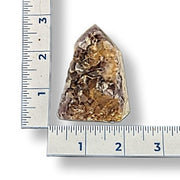 Amethyst next to a ruler on a white background