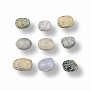 Assorted small rocks on a white background.