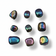 Multicolored stones with iridescent properties on a white background .