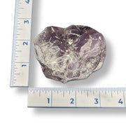 Amethyst next to a ruler on a white background