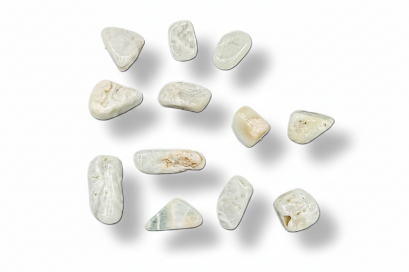 A set of polished light blue tumbled stones or pendants arranged on a plain white background with soft drop shadows.