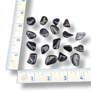 Set of blue goldstone rocks on a white background with a ruler for scale.