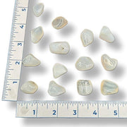Set of opalized agate crystals with a ruler for scale on a white background