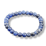 Blue beaded bracelet on a white background