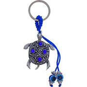 Tortoise-shaped keychain with blue accents on a white background