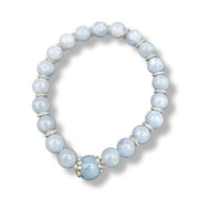 Blue beaded bracelet with gold accents on a white background