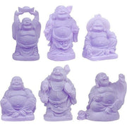Set of six purple Buddha statues on a white background