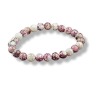 Marbled pink and white beaded bracelet on a white background