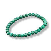 Green beaded bracelet on a white background