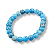 Blue beaded bracelet on a white background