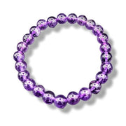 Purple beaded bracelet on a white background