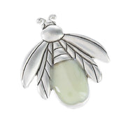 Silver Charm with a green stone on a white background