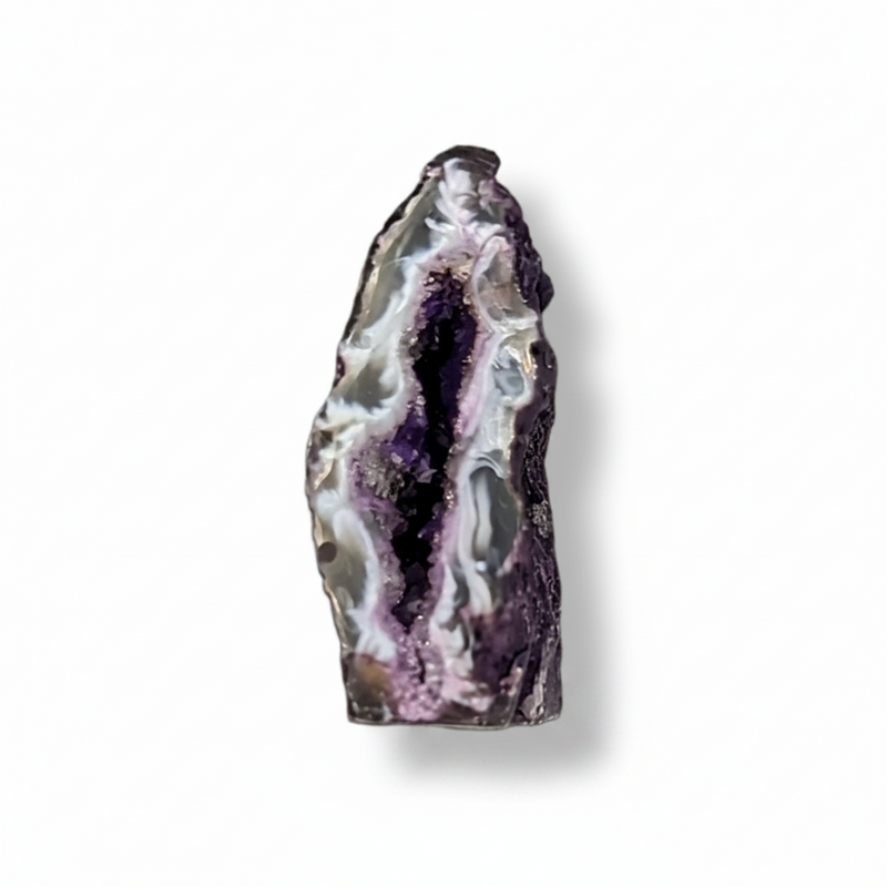 A polished natural geode slice with a dark purple outer matrix and a glittering interior lined with silver and white druzy crystals, shown on a clean white background with a soft drop shadow.
